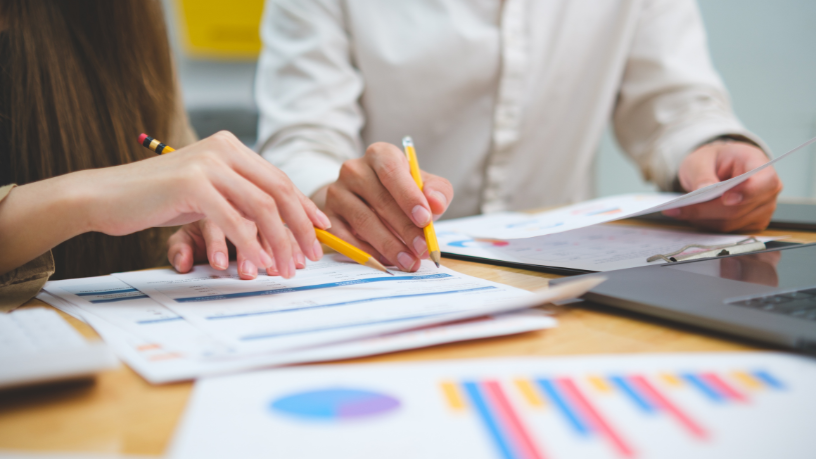 Ambiente executivo com relatórios e gráficos de mercado, simbolizando análise de tendências e estratégia empresarial segundo Victor Boris Santos Maciel.